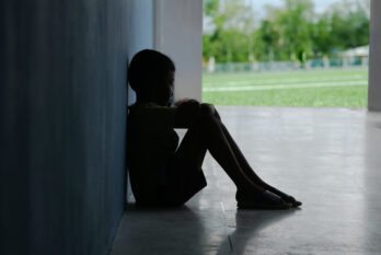 Child sitting alone gun violence trauma
